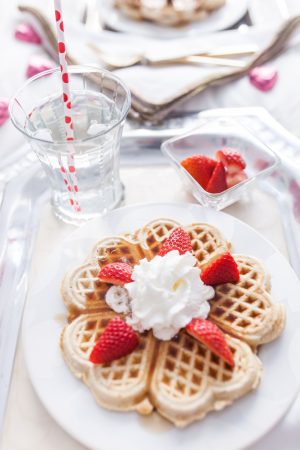 Waffles with whipped cream and strawberries for Valentine's Day Breakfast in bed by Fashionable Hostess