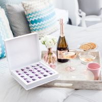 Classsic Easter Hostess Gifts, Santa Margherita Prosecco, Maggie Louise Confections Easter Chocolates, Laduree Pink Candles