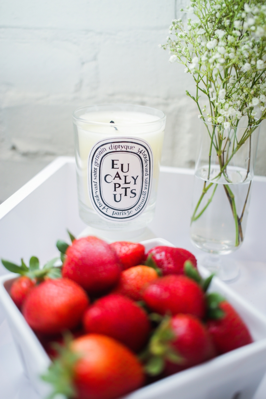 Juicy Red Strawberries in a Crate and Barrel Glass Carton with a Diptyque Eucalyptus Candle and Babys Breath on Fashionable Hostess